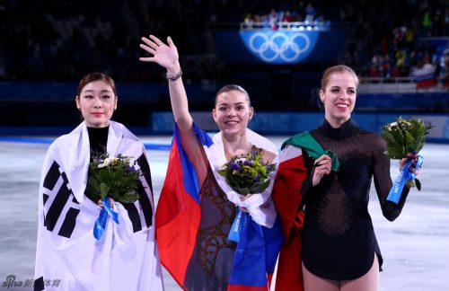 SOCHI, RUSSIA - FEBRUARY 20: (L-R) Silver medalist Yuna Kim of South Korea, gold medalist Adelina Sotnikova of Russia and bronze medalist Carolina Kostner of Italy celebrate during the flower ceremony for the Ladies' Figure Skating on day 13 of the Sochi 2014 Winter Olympics at Iceberg Skating Palace on February 20, 2014 in Sochi, Russia. (Photo by Ryan Pierse/Getty Images)